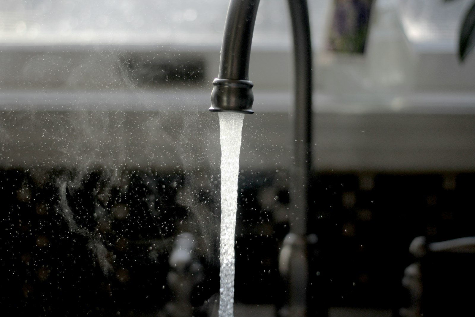 Faucet with running water, representing leak detection and repair in San Antonio TX